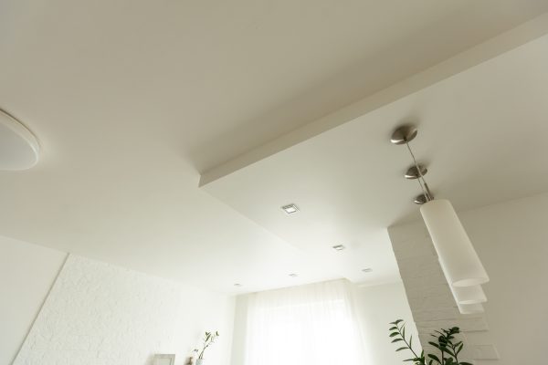 Clean gypsum board ceiling in construction site. Under construction a new house with interior modern Clean gypsum board ceiling in construction site. Under construction a new house with interior modern